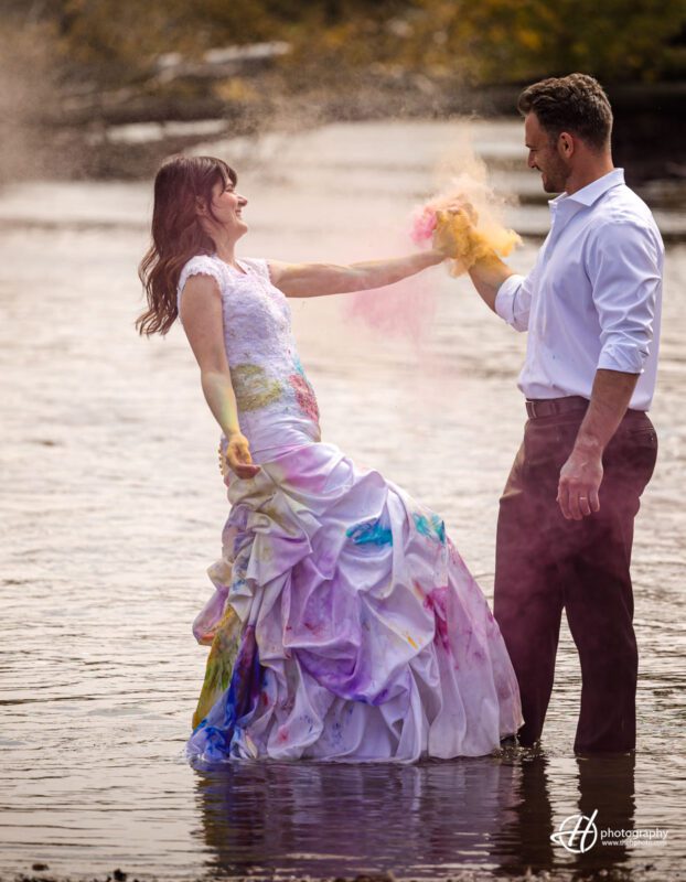 Colorful anniversary joy: Couple enjoying their special day in a water and color bomb photoshoot